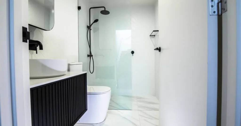 Renovated bathroom with freestanding bath, glass shower and black tapware