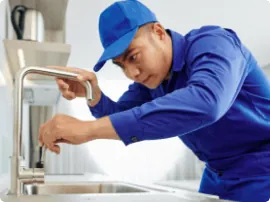 Plumber installing a tap
