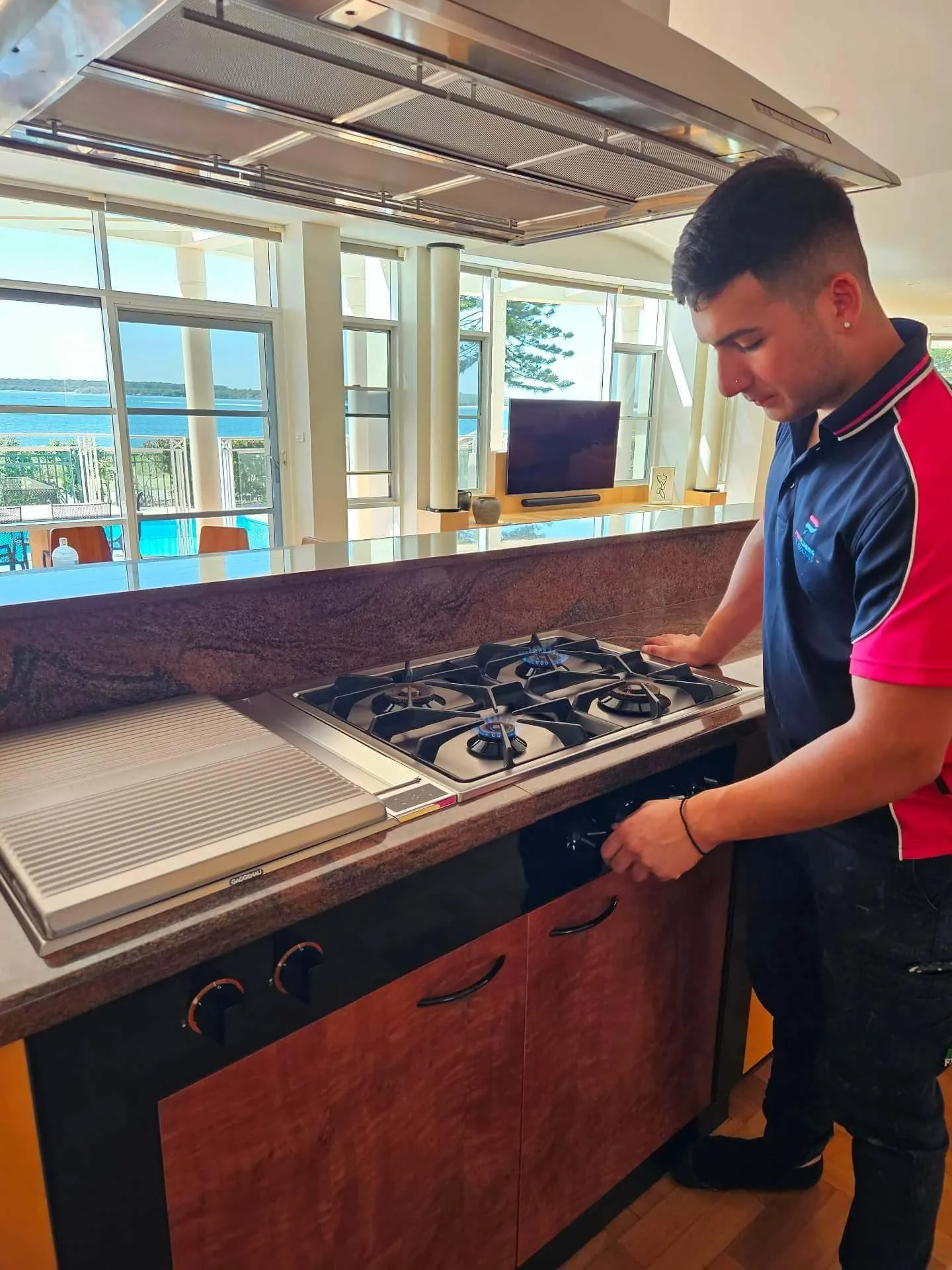 Pink Plumbing plumber installing a gas cooktop